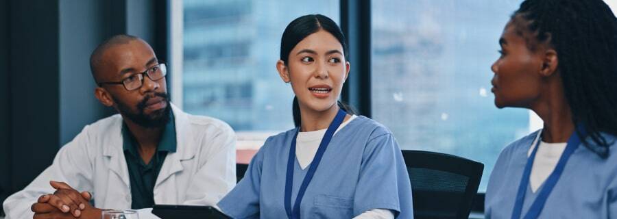 Doctors and nurses talking at in conference room