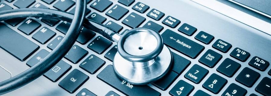 Stethoscope resting on a keyboard