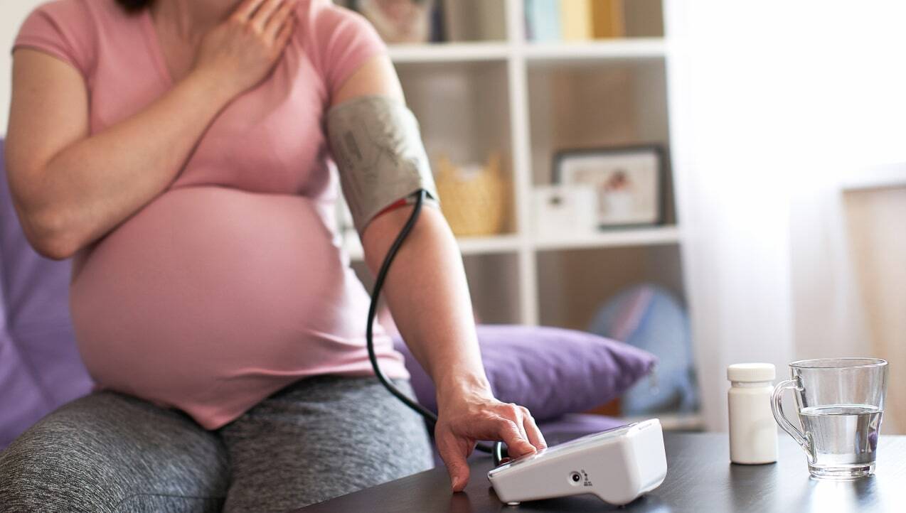 Pregnant woman testing blood pressure