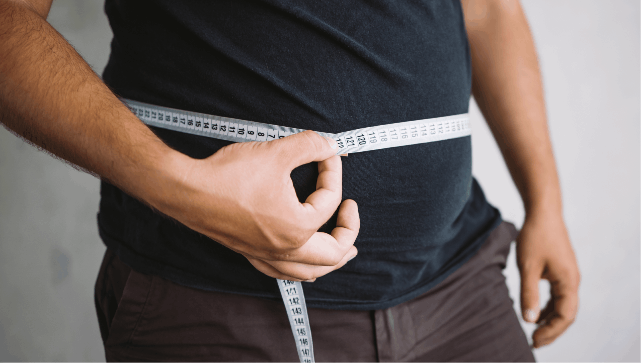 man measuring large stomach with tape measure